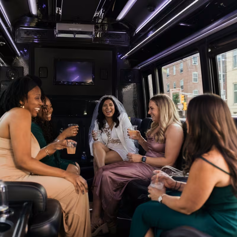 Party bus interior with wraparound leather seating and LED lighting in Durham