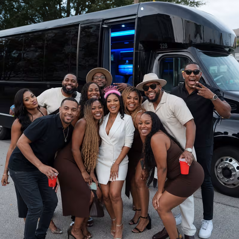 Group boarding a white charter bus for Birthday Transportation transportation in Durham