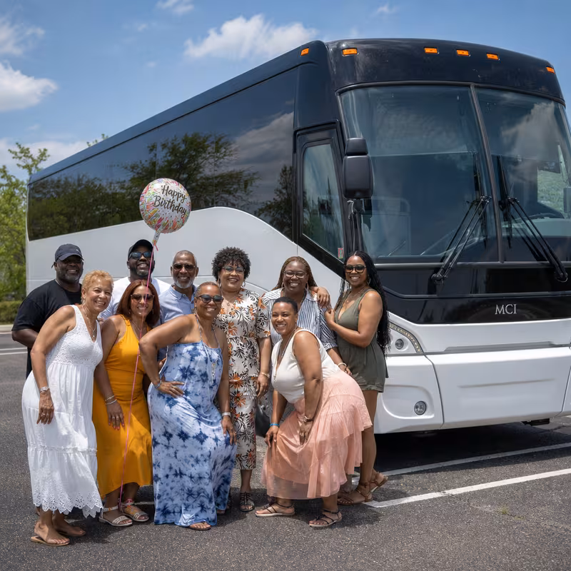 Passengers loading luggage while boarding an Durham group shuttle