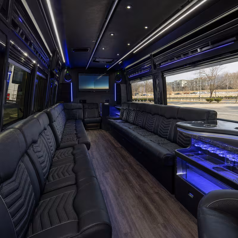 Party bus interior with wraparound leather seating and LED lighting in Durham