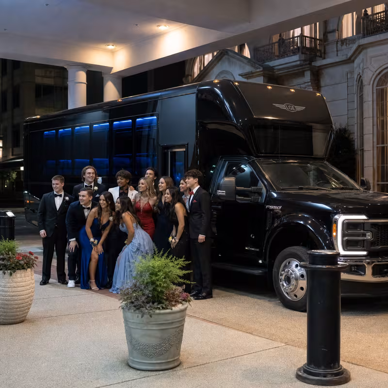 Party bus interior with wraparound leather seating and LED lighting in Durham
