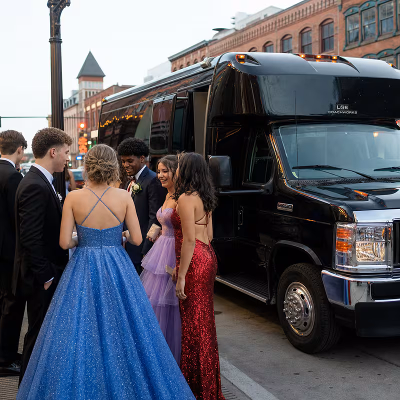 Passengers loading luggage while boarding an Durham group shuttle