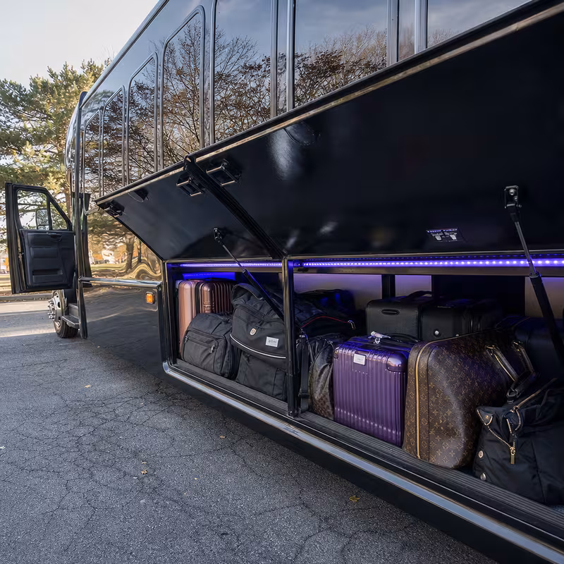 Party bus interior with wraparound leather seating and LED lighting in Durham