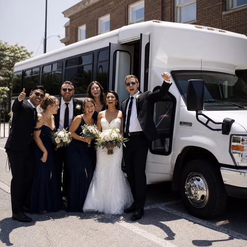 Passengers loading luggage while boarding an Durham group shuttle