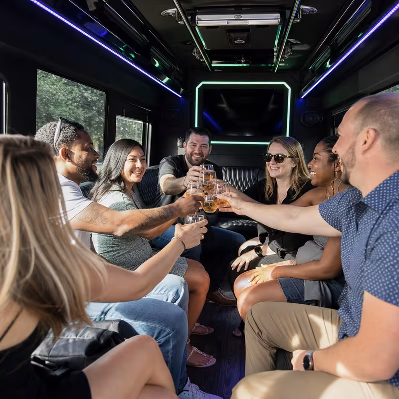 Group boarding a white charter bus for Winery & Brewery Tour Transportation transportation in Durham