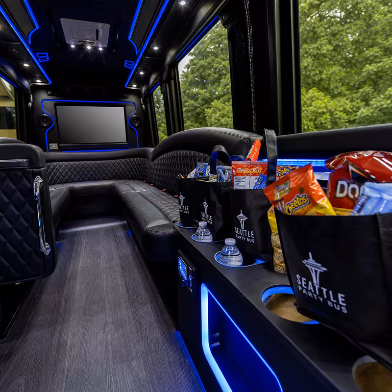 Party bus interior with wraparound leather seating and LED lighting in Durham